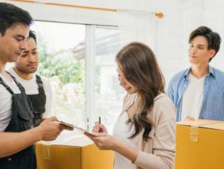 A couple signing an agreement with movers